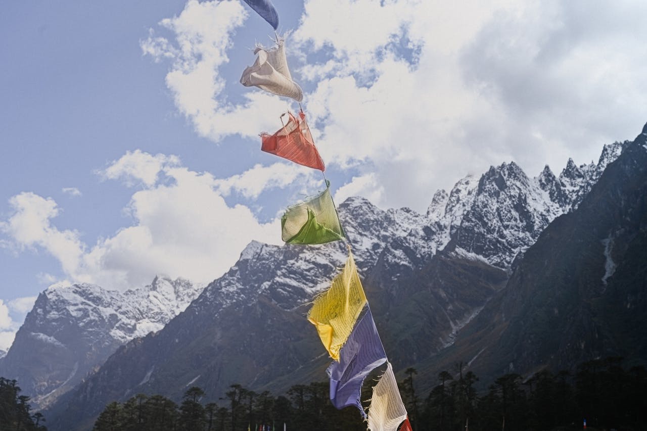 About Vibrant prayer flags flutter before the dramatic mountains of Sikkim, India.